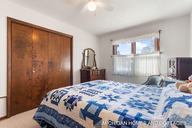 carpeted bedroom featuring a closet, a textured ceiling, and a ceiling fan