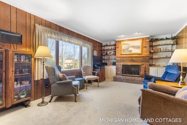 carpeted living area with a brick fireplace, built in features, wood walls, and ornamental molding