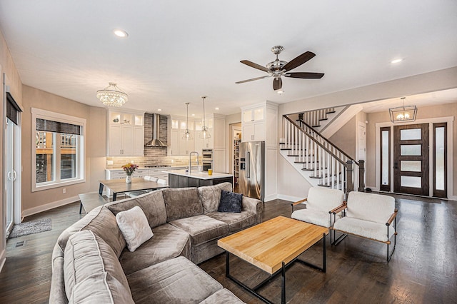 living area with stairs, recessed lighting, dark wood finished floors, and baseboards