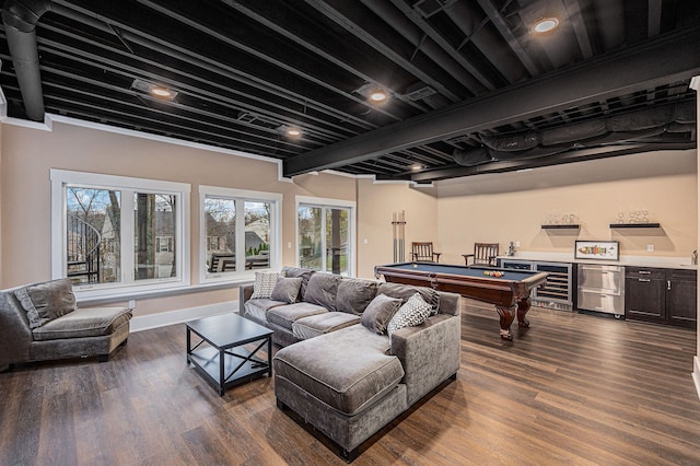 living room featuring a bar, dark wood-type flooring, wine cooler, and a wealth of natural light