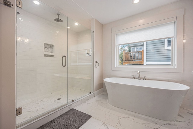 full bath with recessed lighting, a soaking tub, marble finish floor, and a shower stall