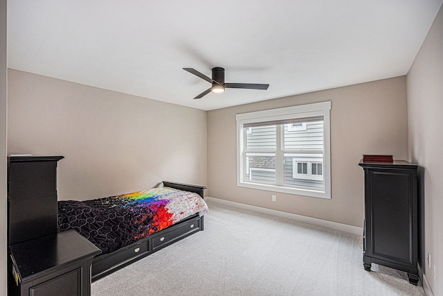 bedroom with a ceiling fan, baseboards, and light carpet