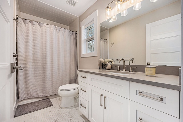 bathroom featuring vanity, a shower with shower curtain, toilet, and visible vents