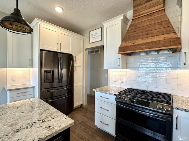 kitchen featuring range with two ovens, fridge with ice dispenser, dark wood-type flooring, and white cabinetry