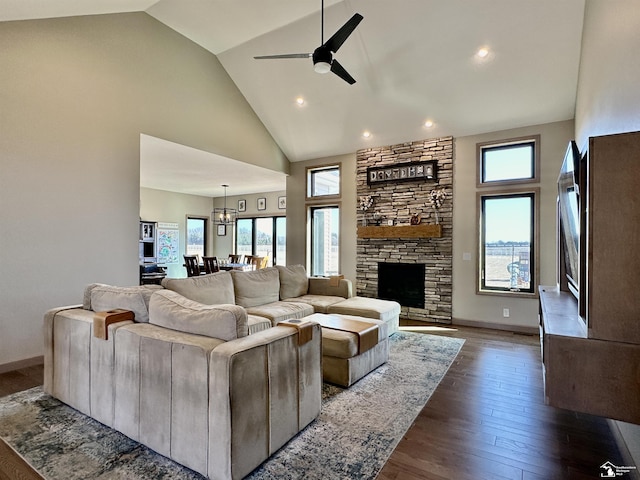 living room with high vaulted ceiling, dark wood-style floors, a fireplace, baseboards, and ceiling fan