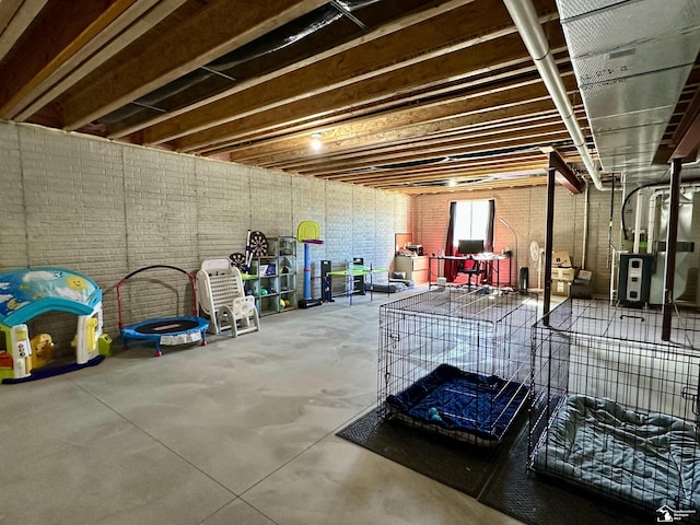 basement featuring brick wall