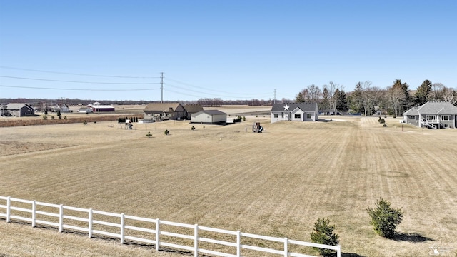 view of yard featuring a rural view and fence