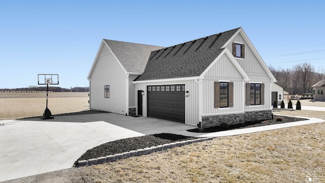 view of home's exterior featuring an attached garage, board and batten siding, concrete driveway, and roof with shingles