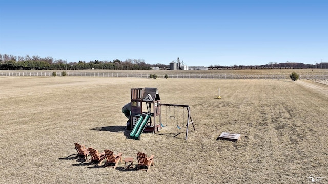 view of yard with a playground and a rural view