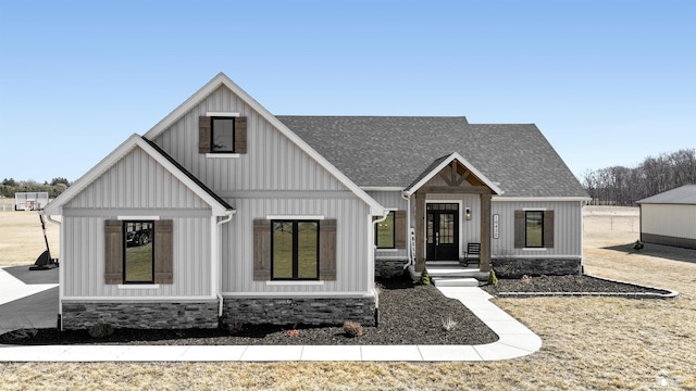 modern inspired farmhouse featuring french doors, board and batten siding, and a shingled roof