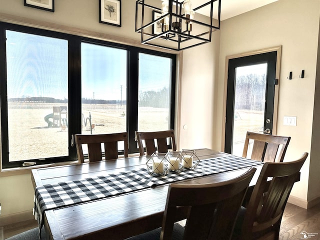 dining area featuring baseboards and wood finished floors