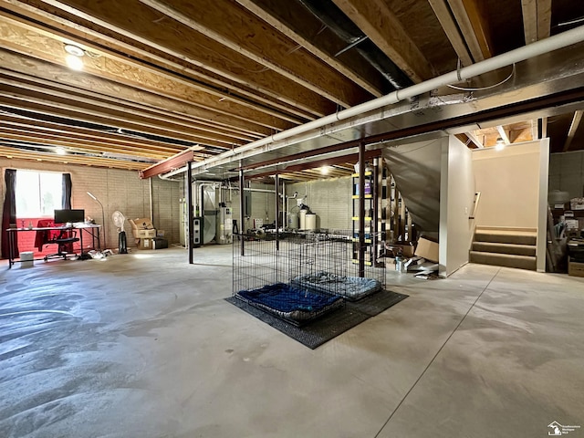 below grade area featuring gas water heater and stairway