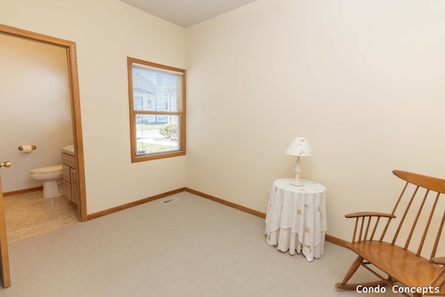 living area with light carpet, visible vents, and baseboards