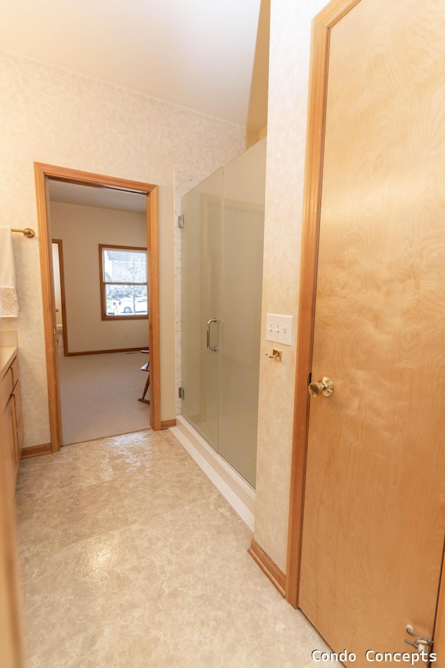 bathroom with a stall shower and vanity