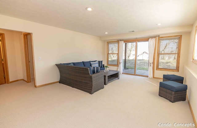 living area featuring visible vents, recessed lighting, carpet, and baseboards