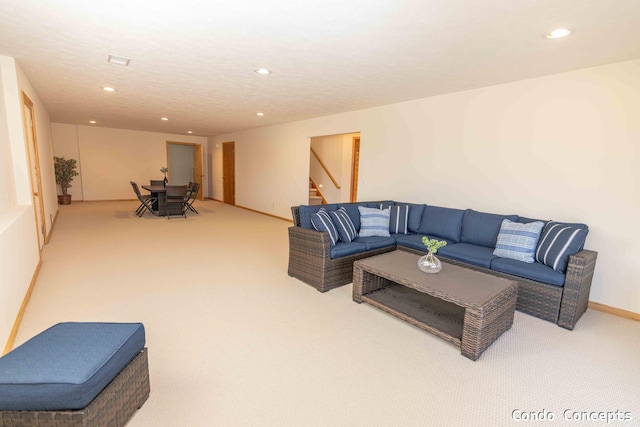 carpeted living area with recessed lighting, stairway, and baseboards