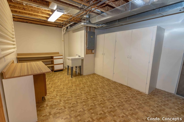 unfinished basement with electric panel and a sink