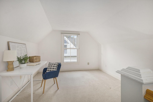 carpeted office space with baseboards and lofted ceiling