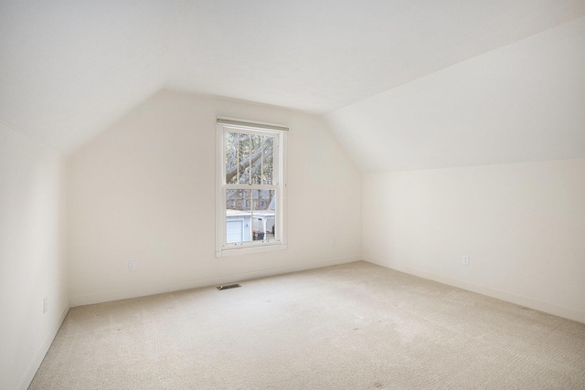 bonus room with lofted ceiling, carpet, visible vents, and baseboards