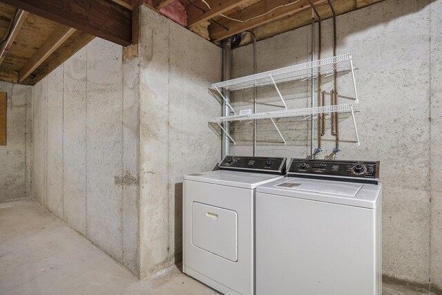 clothes washing area with washer and dryer and laundry area