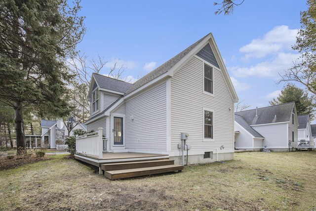 view of property exterior featuring a deck and a yard