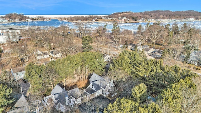 drone / aerial view with a forest view and a water view