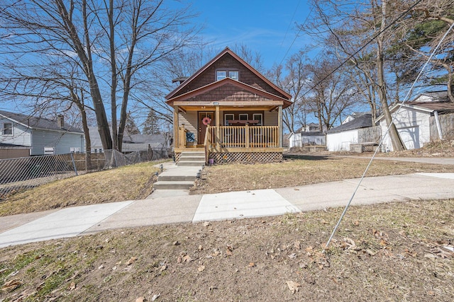 view of front of property featuring an outbuilding, covered porch, and fence