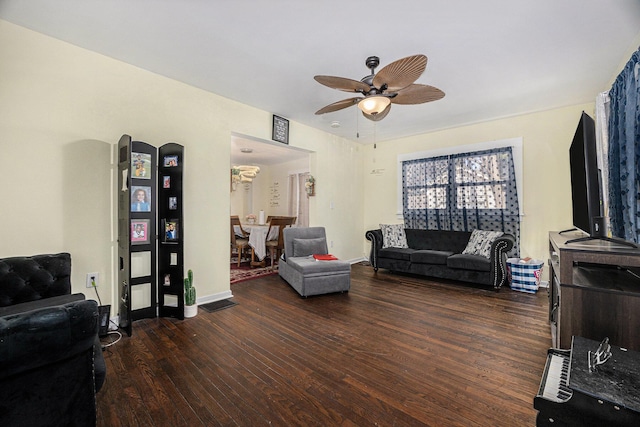 living room with baseboards, ceiling fan, and wood finished floors