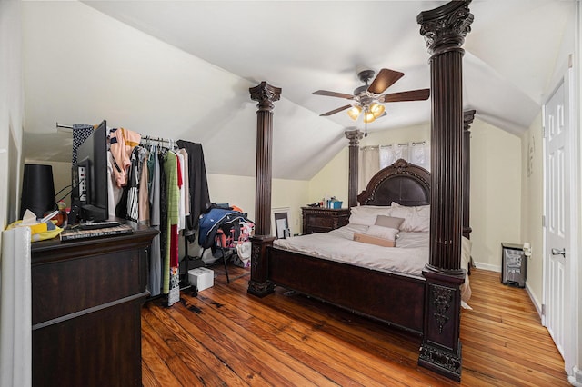 bedroom with ceiling fan, baseboards, lofted ceiling, ornate columns, and wood-type flooring