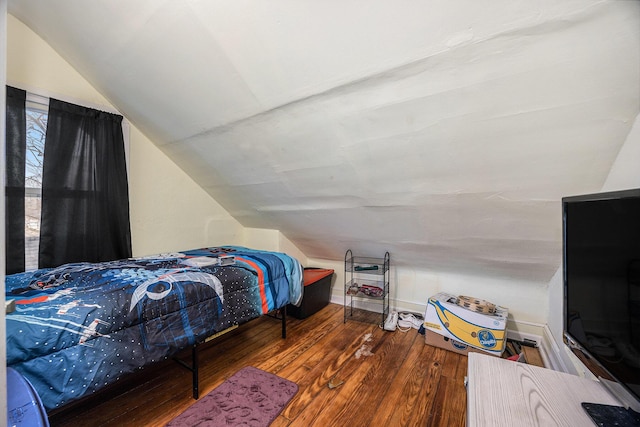 bedroom with baseboards, wood-type flooring, and vaulted ceiling