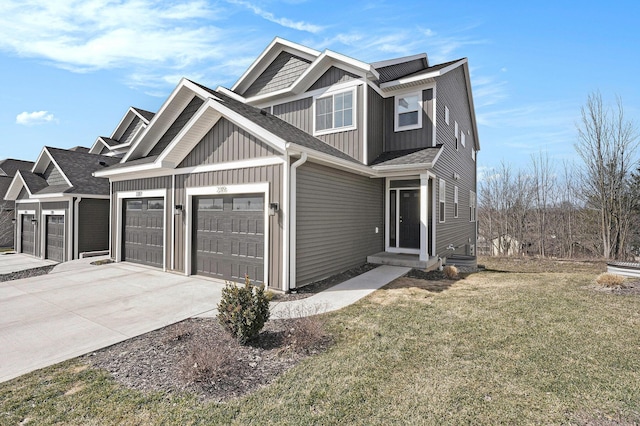 view of front facade with board and batten siding, entry steps, concrete driveway, a front yard, and a garage