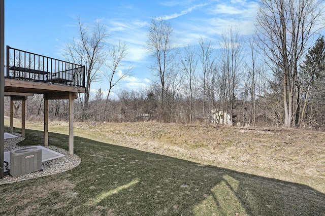 view of yard with a wooden deck and cooling unit