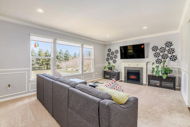 carpeted living room featuring crown molding, a decorative wall, recessed lighting, and a fireplace