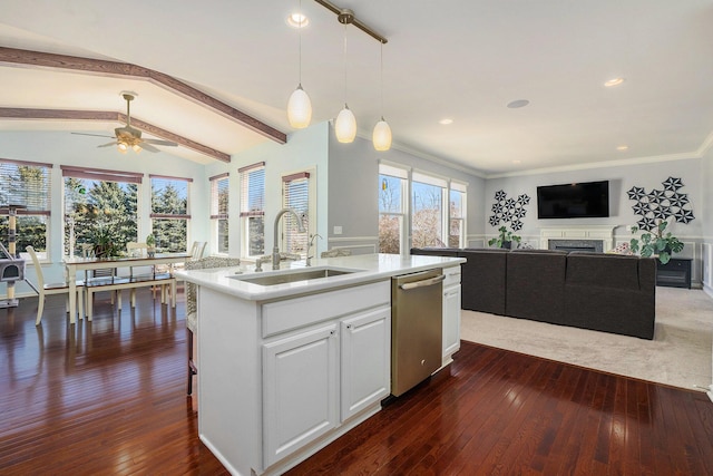 kitchen with lofted ceiling with beams, a fireplace, dark wood-style flooring, a sink, and dishwasher