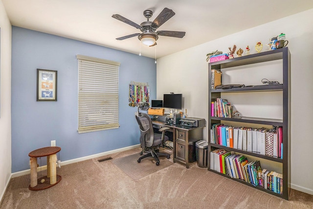 office area with a ceiling fan, carpet, and baseboards