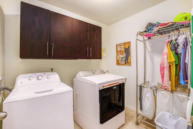 washroom featuring light tile patterned floors, cabinet space, and independent washer and dryer