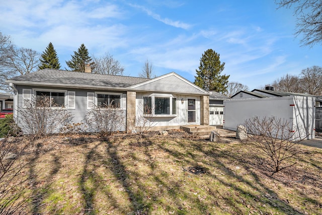 ranch-style home featuring a chimney, roof with shingles, and fence