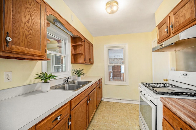 kitchen featuring a baseboard radiator, white gas stove, a sink, light countertops, and under cabinet range hood