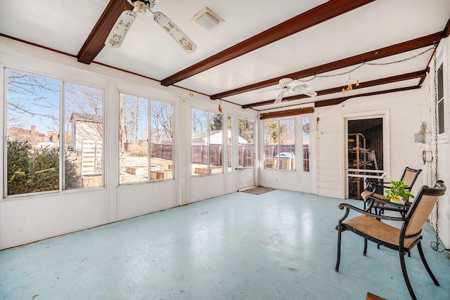 sunroom featuring beamed ceiling and a ceiling fan