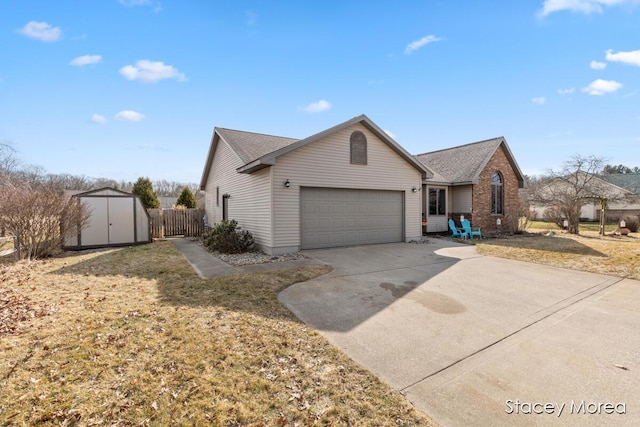 view of front of property with an outbuilding, fence, a storage shed, concrete driveway, and a garage