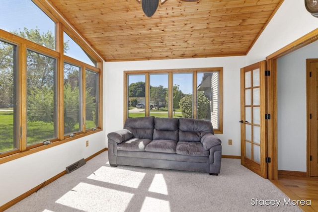 living area with carpet, vaulted ceiling, wood ceiling, and baseboards