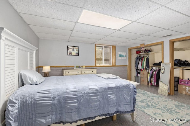 bedroom featuring a paneled ceiling and visible vents