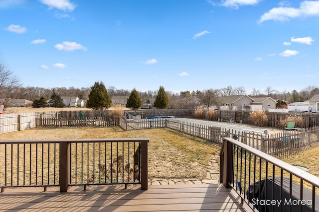 wooden deck featuring a residential view and fence