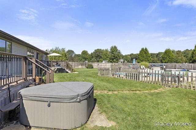 view of yard featuring a pool, a hot tub, fence, stairs, and a deck