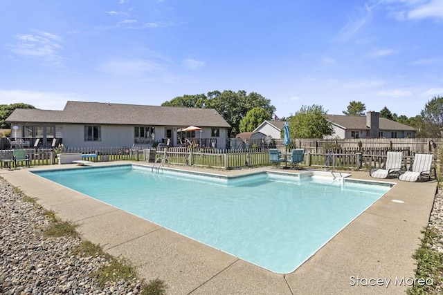 view of pool with a patio area, a fenced in pool, and fence