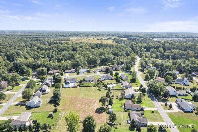 aerial view featuring a wooded view