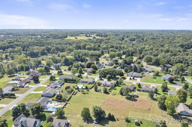 birds eye view of property featuring a view of trees