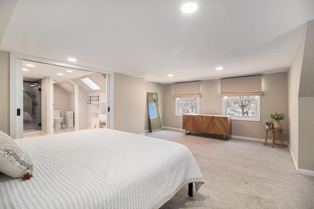 bedroom with ensuite bathroom, recessed lighting, a skylight, baseboards, and light colored carpet