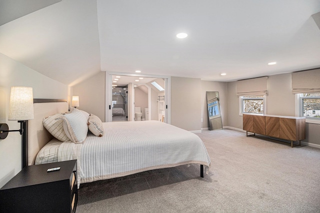 bedroom featuring baseboards, ensuite bath, recessed lighting, an AC wall unit, and light carpet