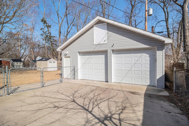 detached garage with a gate and fence